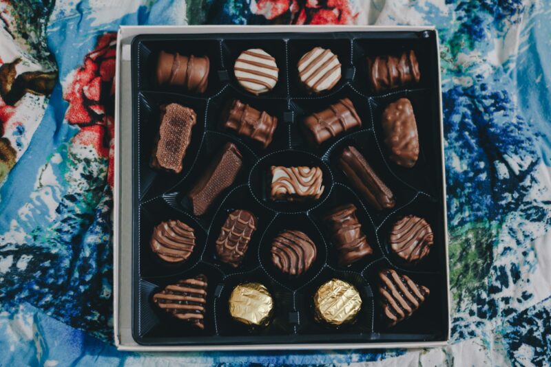 assorted chocolates in a box, on a blue background