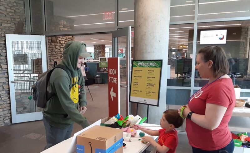 Faculty member Jen Martin distributing stress relief kits to students