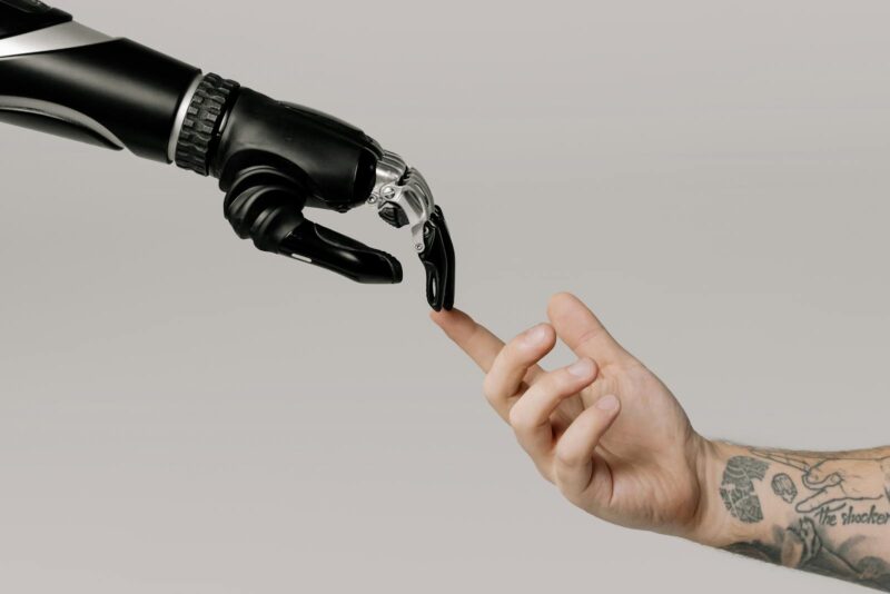 Bionic Hand and Human Hand touching fingers