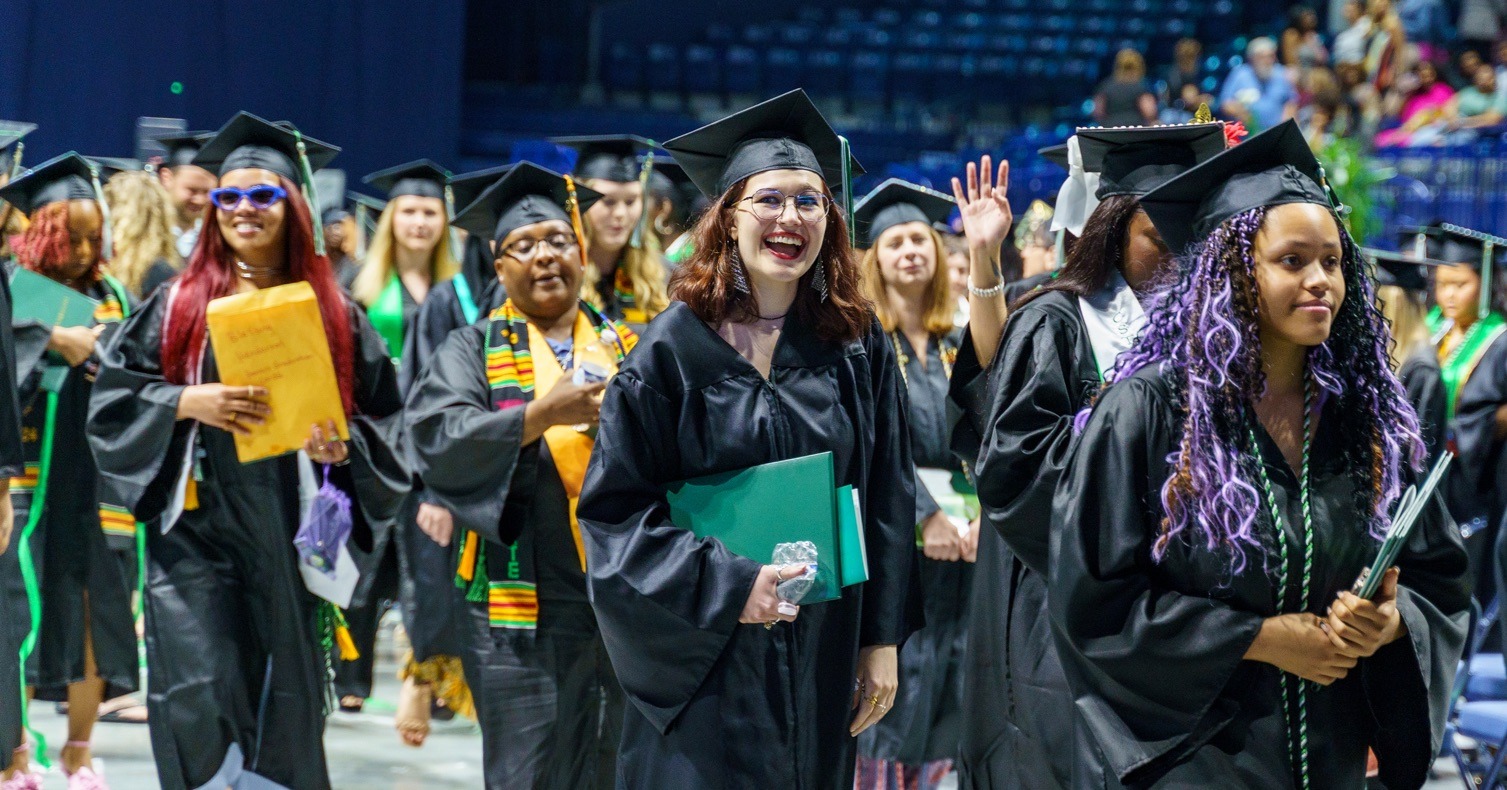 Happy graduates leave the arena after Commencement 2024