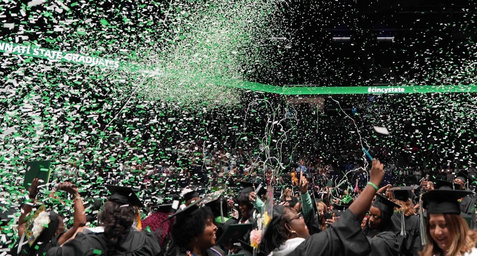 Graduates celebrating during the confetti drop at the end of the ceremony