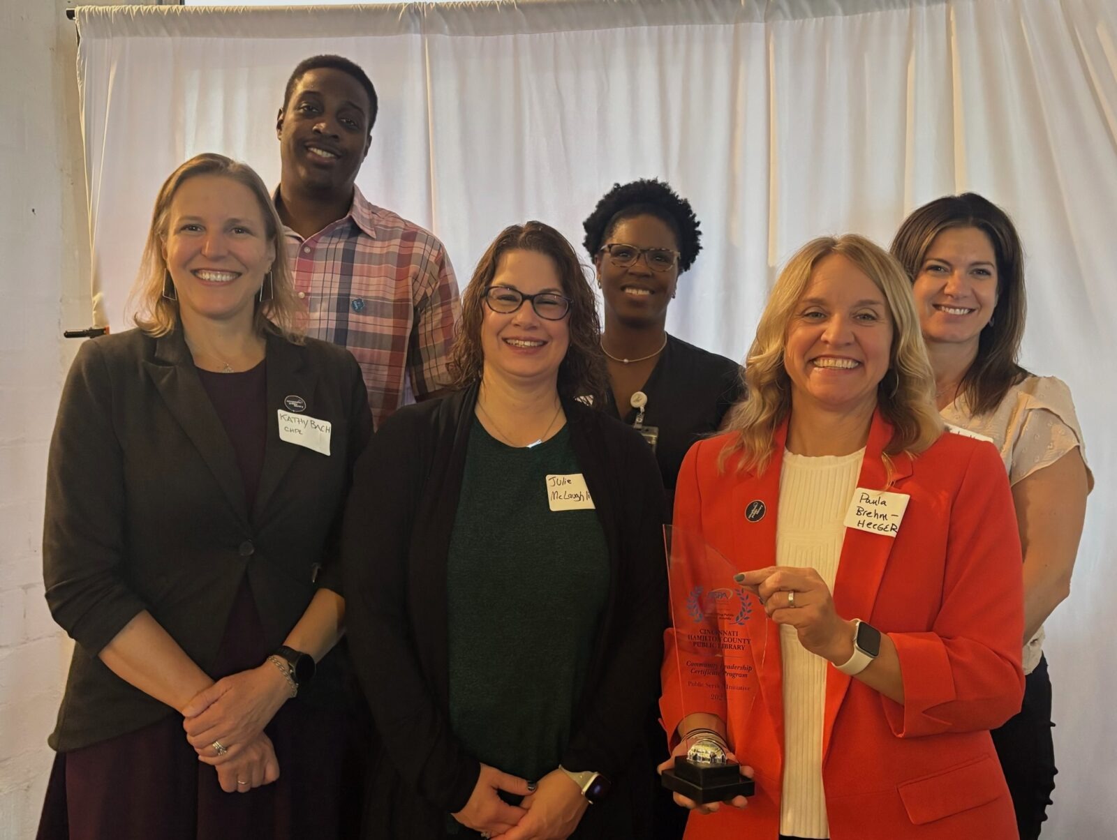 Receiving the Outstanding Public Service Award: Front - Kathy Bach, CHPL; Julie McLaughlin, Cincinnati State; Paula Brehm-Heeger, CHPL Director. Back - Community Leadership Certificate students Michael Guess and Jenna Felsheim; Kyla Hardin, CHPL.