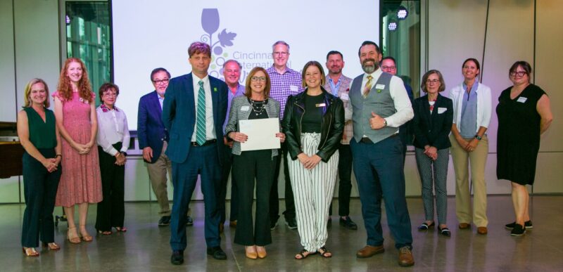 Accepting Cincinnati State's award from the Cincinnati International Wine Festival: Front row - Elliott Ruther, Chief of Advancement & Executive Director of the Cincinnati State Foundation; Yvonne Baker, Dean of the Business Division; Sarah Gagnon, Executive Director of CIWF; Michael Whitley, Director of the Midwest Culinary Institute. Back row - CIFW leaders and staff members