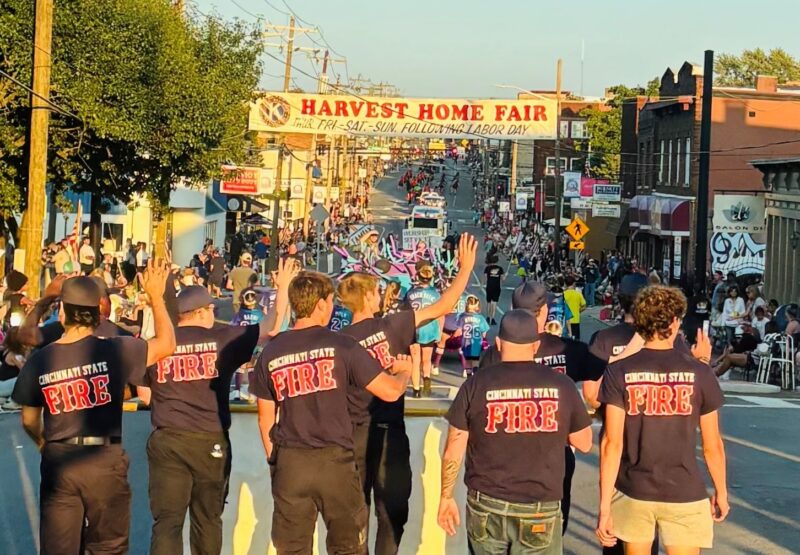 Fire Service Technology students waving to the crowd while they walk in the Harvest Home Parade