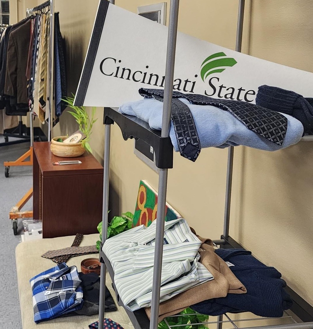 Items from Cincinnati State Career Closet in a display with a Cincinnati State pennant