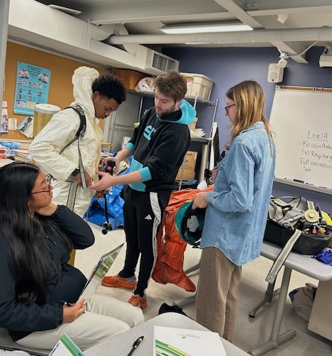 Students trying on OSHA safety gear at HS Environmental Day - Nov. 2025