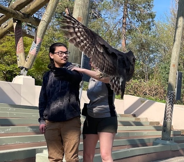 Biology student Sawyer Va with owl at Cincinnati Zoo