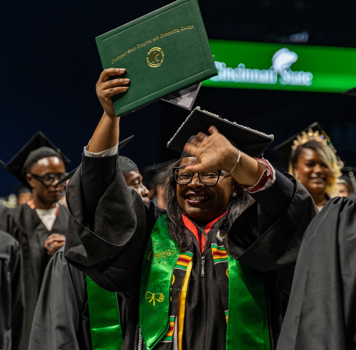 Graduate holding her diploma