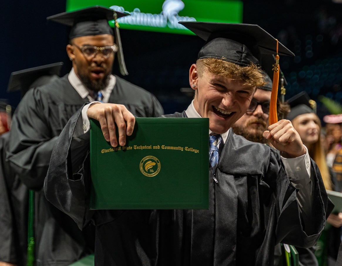 Graduate holding his diploma