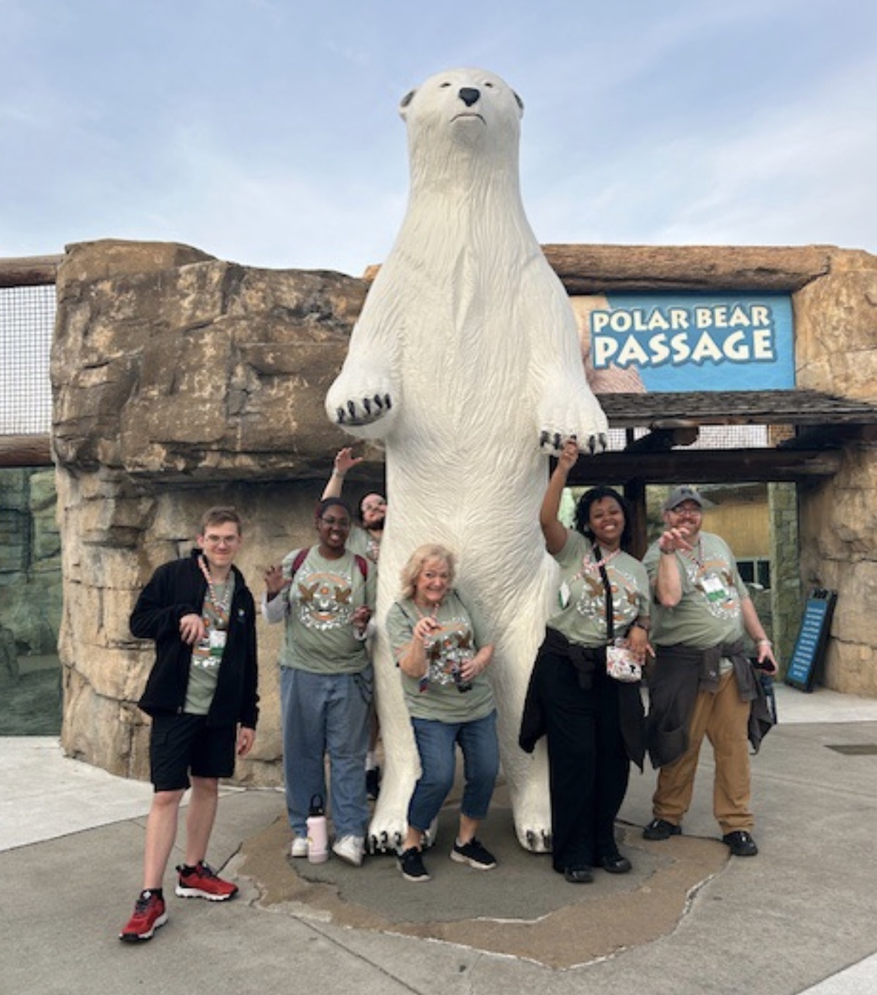 EVT students and faculty pose with a large polar bear statue at the Kansas City Zoo