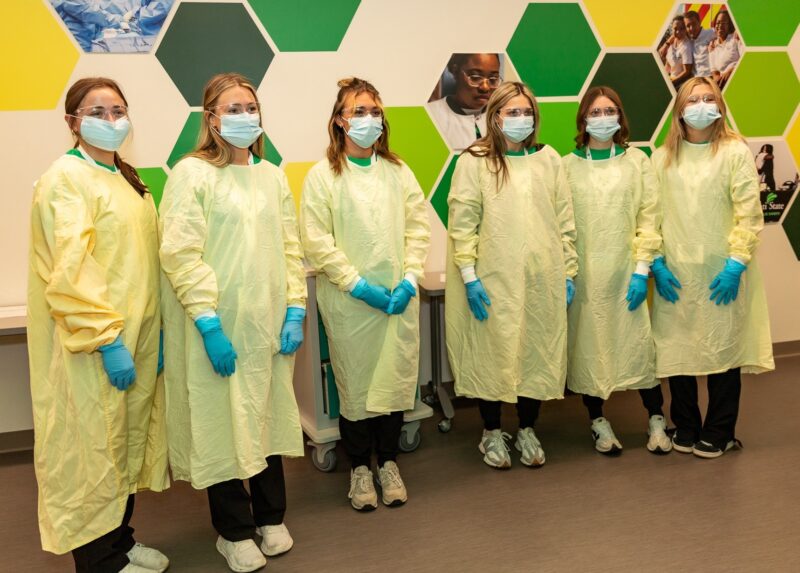 Group of students in yellow surgical gowns at Scrubs Camp 2026