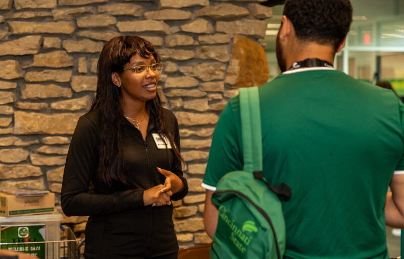 Staff member greeting a student