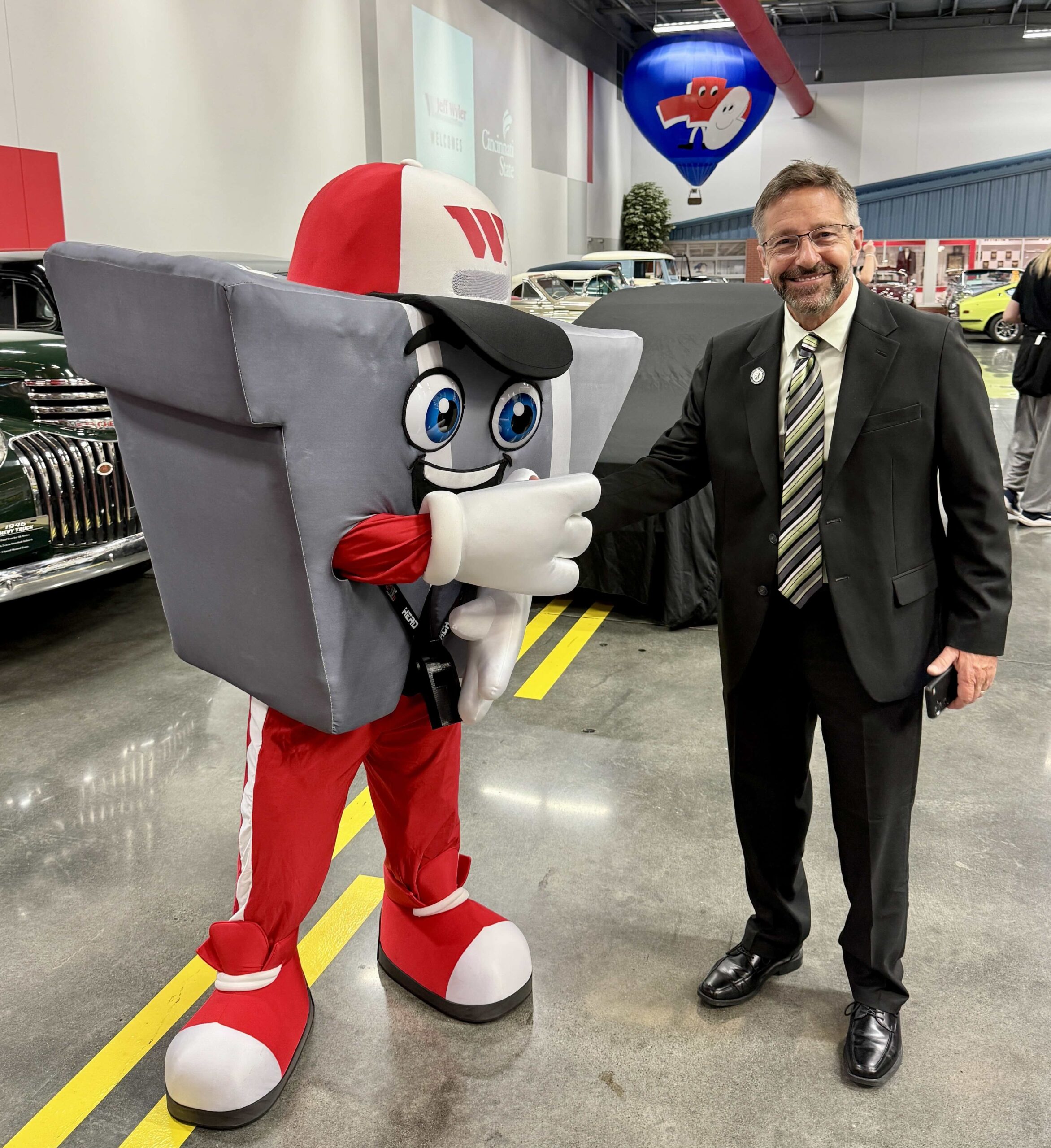 President Robbin Hoopes with Enzo Wyler, the Jeff Wyler Automotive Family mascot
